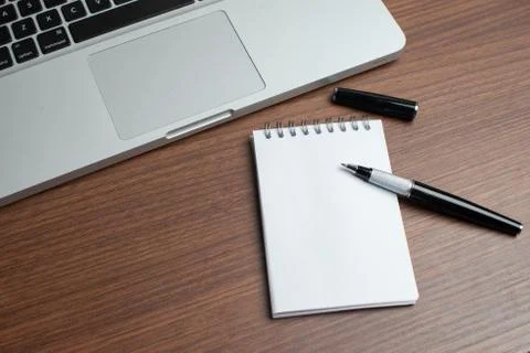 Laptop with notepad and pen Stock Photos