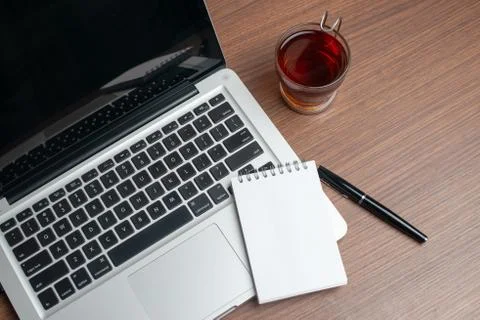 Laptop with notepad and pen Stock Photos