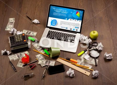 Laptop on office desk with business website on screen Stock Photos