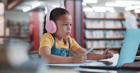Laptop, online class and child with headphones, library and writing test for Stock Footage 319762883