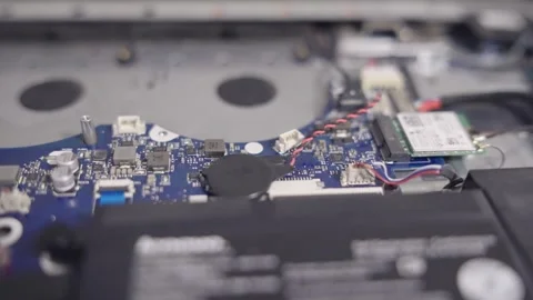A laptop is open and the battery is removed with mother board components visi Stock Footage 344908987