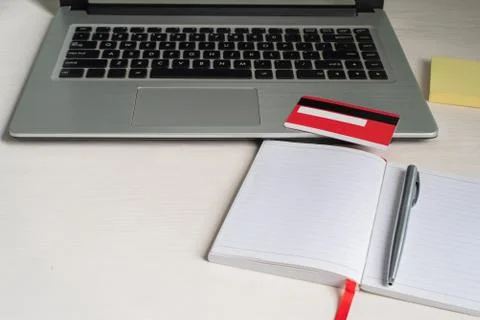 Laptop, open notebook, pen, credit card, paper note Stock Photos
