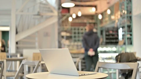 Laptop Open on Table in Empty Cafe Stock Footage 126961090