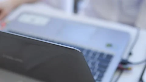 Laptop is open on a table with a person in the background Stock Footage 310825229