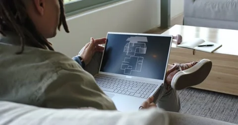 Laptop opening digital floor plan, scrolling blueprint, tilting screen on couch Stock Footage 341736233