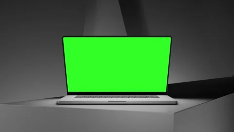 Laptop opens with a green screen on a white table, smooth zoom in, abstract.. Stock Footage 276425546