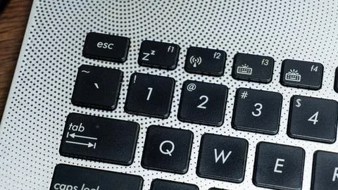 Laptop or computer keyboard with black keys and silver body Stock Photos