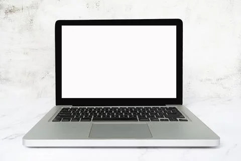 Laptop or notebook with blank screen on white table. Copy space. Foto stock