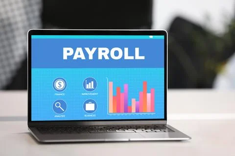 Laptop with payroll data on screen on table Stock Photos