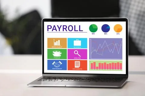 Laptop with payroll data on screen on table Stock Photos