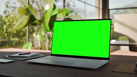 Laptop PC  Blank Green Screen on Desk in Bright Bophilic Office Stock Footage 346760730