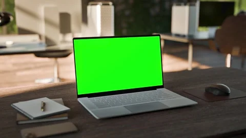 Laptop PC  Blank Green Screen on Desk in Bright Bophilic Office Stock Footage 346760734