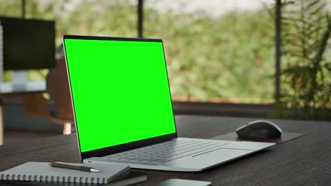 Laptop PC  Blank Green Screen on Desk in Bright Bophilic Office Stock Footage 346760741