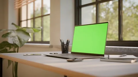 Laptop PC with Green Screen on Office Desk in Sunny Room - Perspective View Stock Footage 341795621
