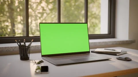 Laptop PC with Green Screen on Office Desk in Sunny Room - Perspective View Stock Footage 341795622