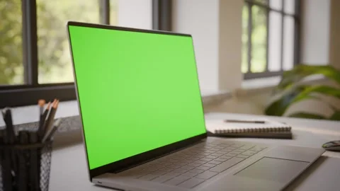 Laptop PC with Green Screen on Office Desk in Sunny Room - Perspective View Stock Footage 341795625