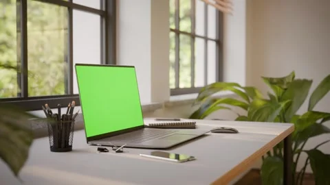 Laptop PC with Green Screen on Office Desk in Sunny Room - Perspective View Stock Footage 341795626