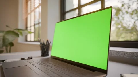 Laptop PC with Green Screen on Office Desk in Sunny Room - Perspective View Stock Footage 341795629