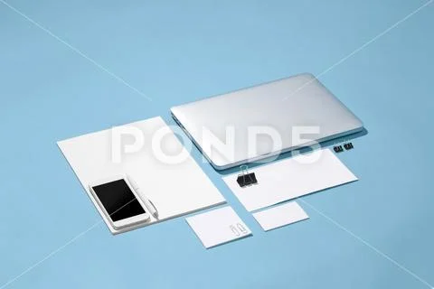The laptop, pens, phone, note with blank screen on table Stock Photos