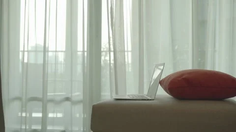 A laptop is on a pillow on a couch Stock Footage 313554307
