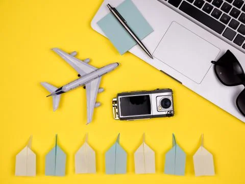 Laptop, plane, camera, pen, notes, keyboard and paper planes Stock Photos