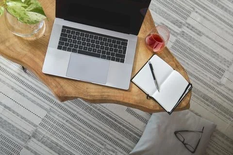 Laptop, plants, and notebook creating a cozy work from home setup Stock Photos