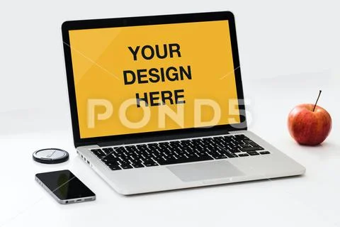 Laptop with red apple fruit, coffee and smartphone on desk mockup PSD Template