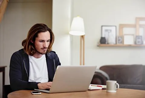 Laptop, remote work and typing with man in home living room for startup pla.. Stock Photos