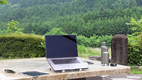 Laptop rests on stone table, screen dark Vídeo Stock 340433121