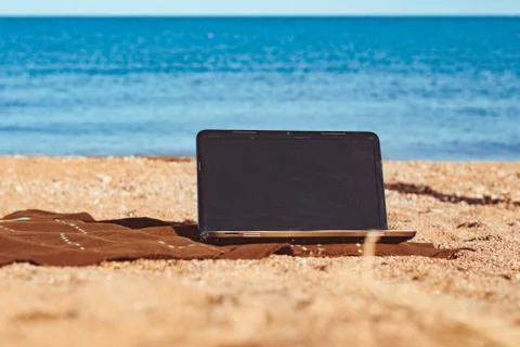 The laptop in the sand Stock Photos