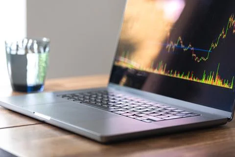 Laptop screen with candlestick chart. Online trading and investment research. Stock Photos