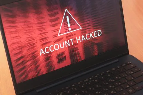 Laptop screen concept with white text Account hacked on red abstract backgrou 写真素材