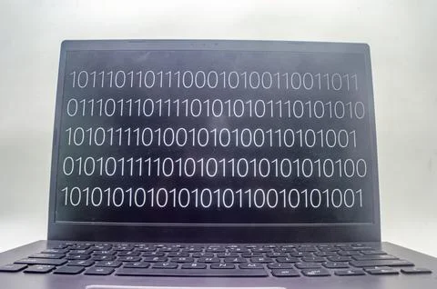 A laptop screen displaying binary code, symbolizing the digital world. Perf.. 写真素材