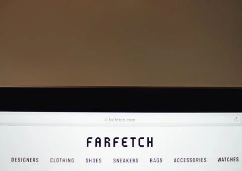 Laptop with screen of farfetch site. Stock Photos