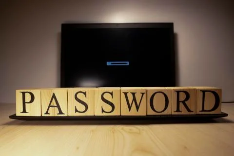 The laptop screen on the table is open. Password word on wooden cubes on lapt Stock Photos