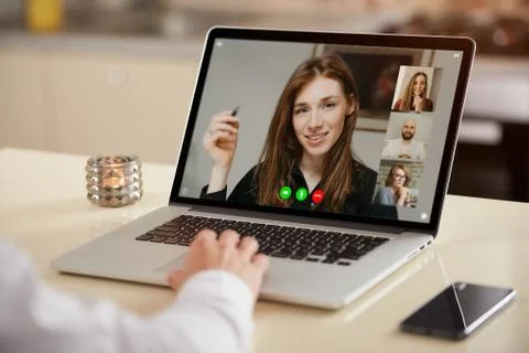 A laptop screen view of the telecommunications application over a man's shoul Stock Photos