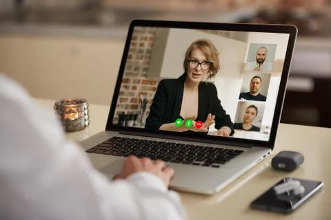 A laptop screen view of the telecommunications application over a man's shoul Stock Photos