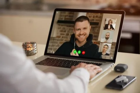 A laptop screen view of the telecommunications application over a man's shoul Stock Photos