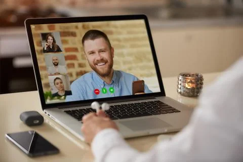 A laptop screen view of the telecommunications application over a man's shoul Stock Photos