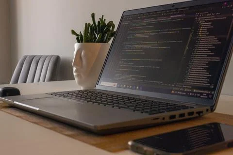 Laptop setup to work from home. Programming and coding. Phone and wireless Stock-Fotos