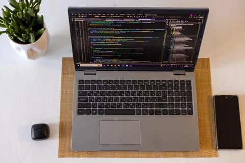 Laptop setup to work from home. Programming and coding. Phone and wireless Stock-Fotos