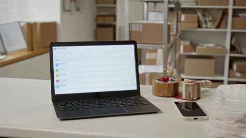 Laptop Showing Ecommerce Inventory Management Software in Warehouse Stock Footage 342589769