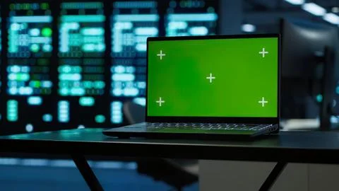 Laptop showing green loading screen in server room Stock Photos