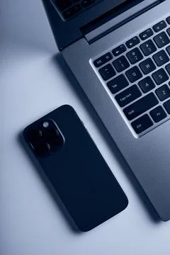 Laptop with smartphone. Close up image. Stock Photos