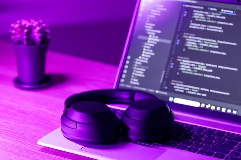  laptop with software code on screen in neon purple light Foto stock