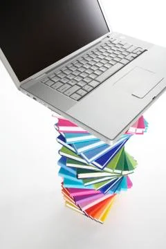 Laptop on spiral book stack, top view Stock Photos
