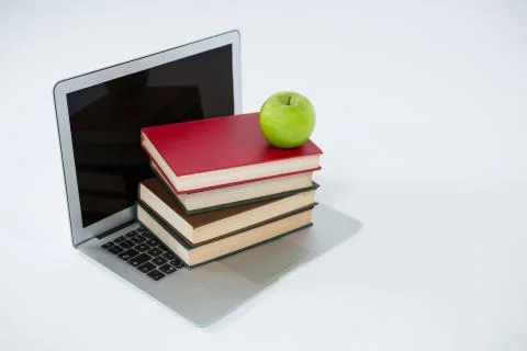 Laptop, stack of books and apple on white background Foto stock