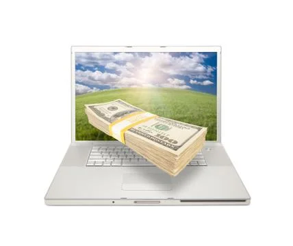 Laptop with Stack of Money Coming From Screen 库存照片