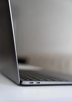 Laptop standing open on white surface Stock Photos