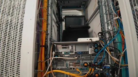 The laptop stands on a stand in front of a large network cabine. Stock Footage 165500175